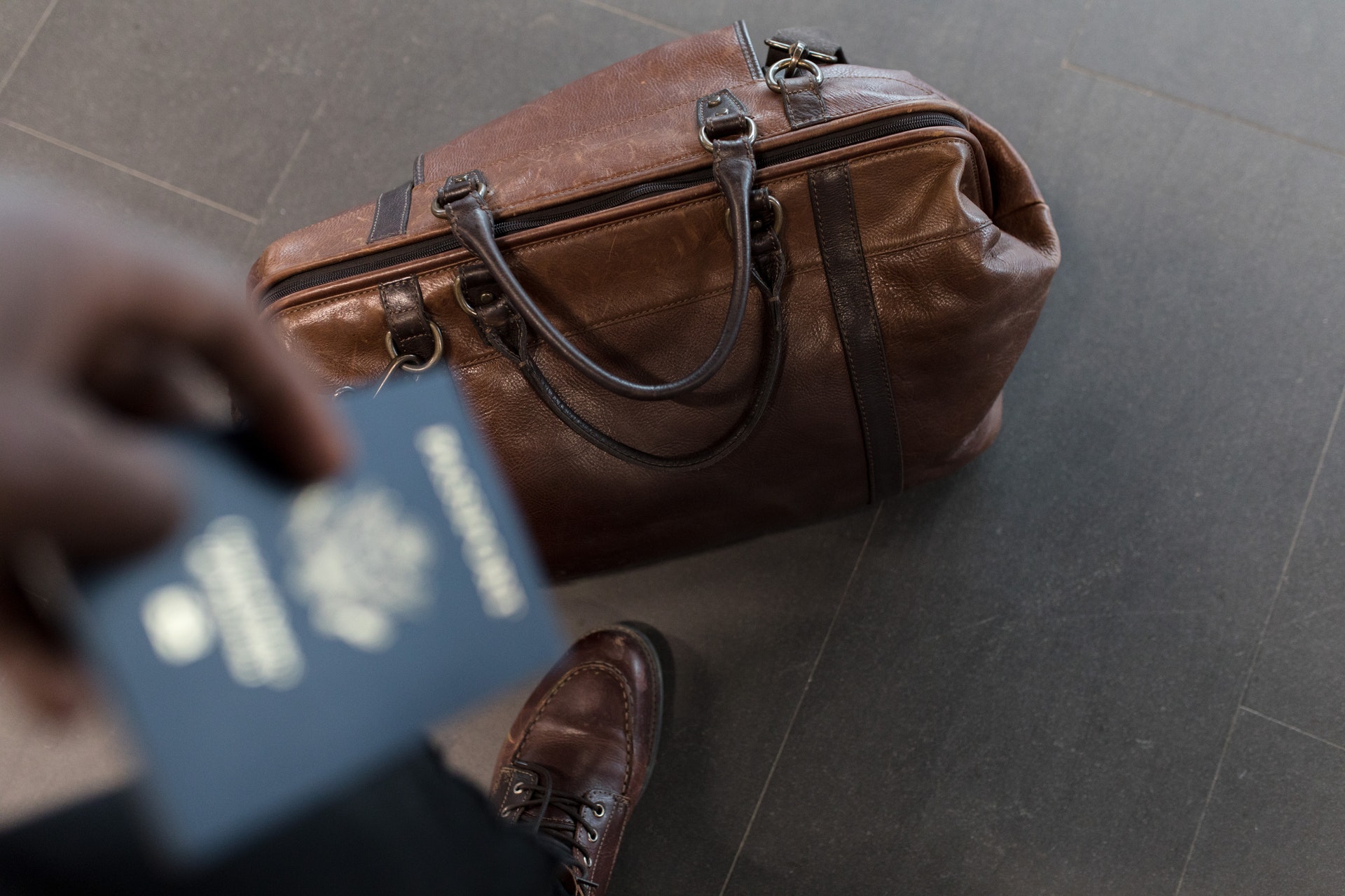 brown luggage and passport